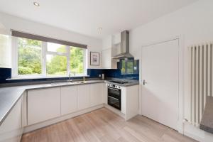 a kitchen with white cabinets and a sink at Lawhead Road East in St. Andrews