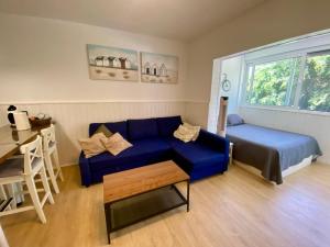 a living room with a blue couch and a table at Loft playa Torviscas,garaje gratis , recién reformado in Adeje +39 photos