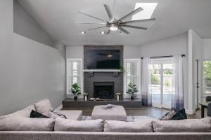 a living room with a couch and a ceiling fan at Luxe Oasis! Pool, Mini-Golf, Games, Pets OK! in Mesa