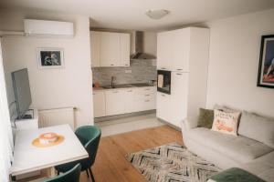 a living room with a couch and a table at Apartman AURELIUS in Vinkovci