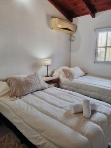 a bedroom with two beds and a window at La quinta in Esquina +19 photos