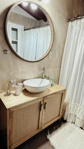 a bathroom with a sink and a mirror at La quinta in Esquina