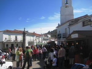 a crowd of people walking down a street in a town at Casa Rural La Fuente del Coso in Cabeza la Vaca
