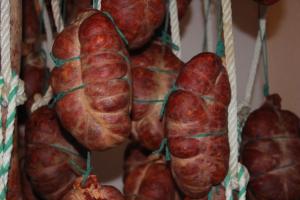 a group of sausages hanging on a wall at Casa Rural La Fuente del Coso in Cabeza la Vaca