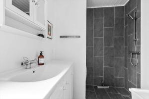 a white bathroom with a sink and a shower at 40385-Juelsminde-Firkanten-5 in Sønderby +26 photos