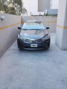 Un coche aparcado en un aparcamiento junto a un edificio. en Sea&Whales lllc, en Puerto Madryn