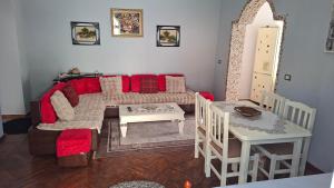 a living room with a couch and a table at Guesthouse Luli Muca in Çorovodë