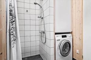a washing machine in a bathroom with a shower at 30042-Malling-Peter-Eriksens-Vej-20 in Malling