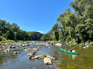 a group of people in a raft on a river at Camping Beaussement Baroudeur in Chauzon +1 photo