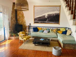 a living room with a couch and a table at Santa Cruz Surf House by Stoke Travel in A dos Cunhados