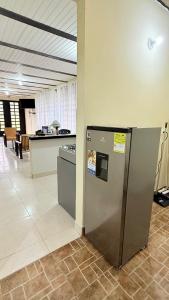 an empty lobby with a refrigerator and a counter at Casa Borbone in Líbano