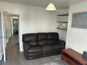 a brown leather couch in a living room at Arden Home in Gillingham