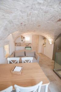 a living room with a couch and a table at Pregio Villas per Suite Oronzo Charme&Pool in Ostuni +8 photos