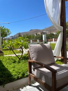 a chair on a porch with a view of the desert at Anna's House in Xerokampos