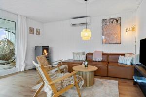 a living room with a couch and a table at 40575-Juelsminde-Pot-Strandby-100 in Sønderby