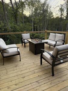 a deck with two chairs and a table and a chessboard at The Brady Retreat Hot tub and pool in McArthur