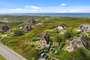 an aerial view of a house on a hill next to the ocean at Watthaus 1 in Tinnum