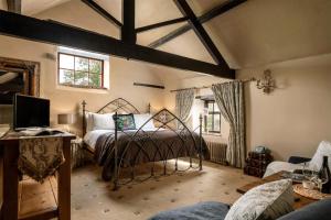 a bedroom with a bed and a tv in a room at Dannah Farm Country House in Shottle