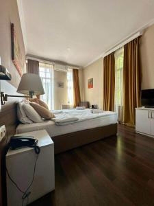 a bedroom with a large bed and a lamp at Boutique Hotel Point in Tbilisi City