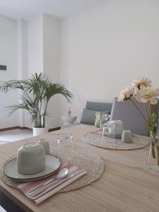 a dining room table with plates and utensils on it at Dream Room Apartment in Illasi