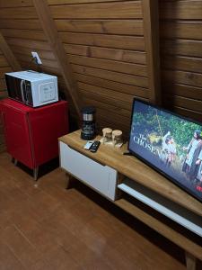 a living room with a tv on a table at Skychale in Governador Valadares +40 photos
