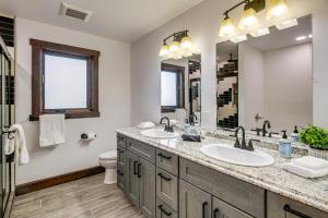 a bathroom with two sinks and a large mirror at Pinedale Getaway Near Hiking, Skiing and Lakes! in Pinedale +16 photos