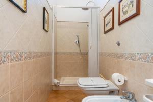 a bathroom with a shower and a toilet and a sink at Oasi Urbana con Terrazza e Vista in Cagliari +17 photos