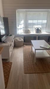 a room with a desk and a table and a window at Maria's Tiny Barn in Homestead
