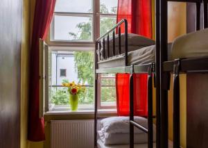 a bunk bed in a room with a window at Let's Rock Party Hostel! Age Limit From 18 until 40! in Kraków