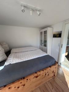 a bed with a wooden frame in a bedroom at Ferienhaus Abendsonne in Sebnitz - Sächsische Schweiz in Sebnitz