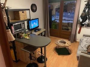 a living room with a table and a television at OZ station 3300m studio mountain in Oz