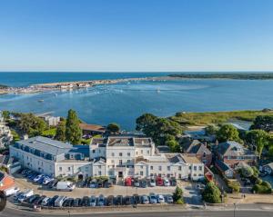 an aerial view of a house and the water at Seaside retreat in Mudeford in Mudeford