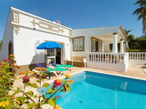 a villa with a swimming pool and a house at Oliveira by Vintage Travel in Guia