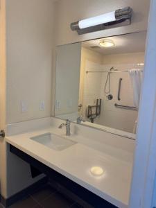 a bathroom with a sink and a large mirror at Candlewood Suites Cotulla by IHG in Cotulla +16 photos