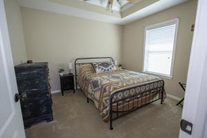 a bedroom with a bed and a window at Farmhouse Charm in College Station