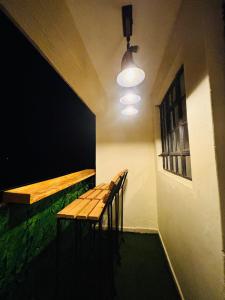 a room with a bench and a table and two chairs at Charme Home in Nanyuki