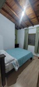 a bedroom with a bed in a room with a wooden ceiling at Finca Guacari (San Gil) in San Gil +13 photos