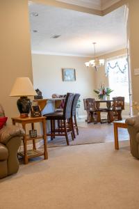 a living room with a table and chairs at Farmhouse Charm in College Station
