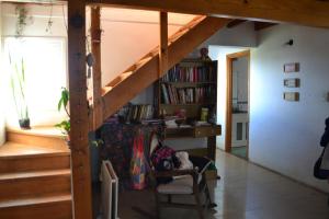 a room with a staircase and a book shelf at Casa Hábitat - Habitaciones en casa compartida con baño privado in San Martín de los Andes