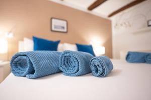 un letto con asciugamani blu sopra di Diso apartments a Napoli