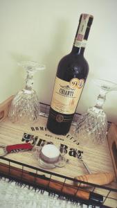 a bottle of wine and two glasses on a table at Apartament Studio Michałek Częstochowa in Częstochowa