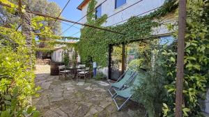 a patio with a chair and a table at Villa Cornelia, Ponte de Lima in Ponte de Lima