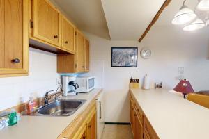 a kitchen with a sink and a microwave at Hi Country Haus 6-15 in Winter Park