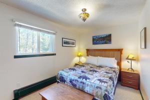 a bedroom with a bed and a window at Hi Country Haus 6-15 in Winter Park +12 photos