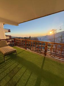 a balcony with a bench and a view of a mountain at Family Ski Getaway Ski In and Out La Parva in Farellones