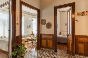 a hallway with a door and a living room at Borel apartment in Volos