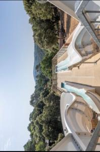an overhead view of a building with a pool and trees at Camping les gorges de provences in Montagnac