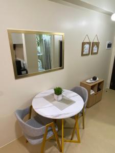 a table and chairs in a room with a mirror at AVIDA TOWERS - Aspira Tower1 in Cagayan de Oro