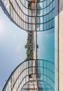 a view of a building with a glass facade at Camping les gorges de provences in Montagnac