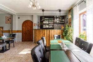 a restaurant with tables and chairs and a bar at Domek przy Base Camp Pieniny in Niedzica Zamek